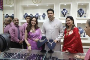 Dr. Saurabh Gadgil CMD PNG Jewellers Madhuri Dixit along with the PNG family inside the store in Indore Madhya Pradesh